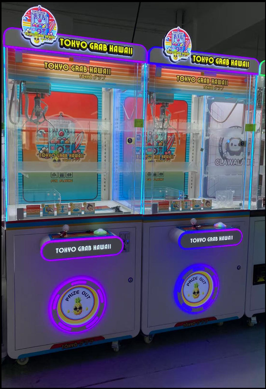 Two arcade claw machines with colorful displays in an indoor setting.